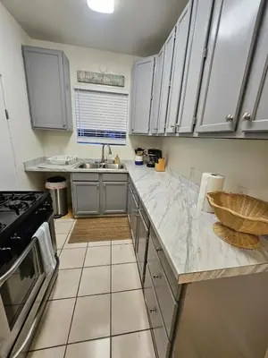 a kitchen with white cabinets and a counter top at The Seabreeze by Coastline Vacation Rentals in San Diego
