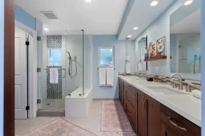 a large bathroom with two sinks and a shower at Golden Hour by Coastline Vacation Rentals in Encinitas