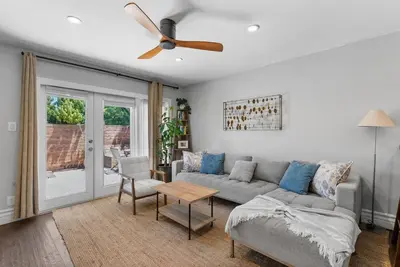 a living room with a couch and a ceiling fan at Serena Encinitas by Coastline Vacation Rentals in Encinitas