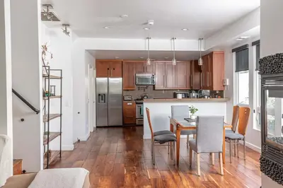 a kitchen and dining room with a table and chairs at Chic Downtown SD Hub for Families & Friends in San Diego