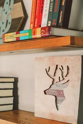 a book shelf with books and a sign on it at The Artist's Loft by Coastline Vacation Rentals in San Diego