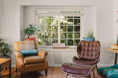a living room with a chair at The Artist's Loft by Coastline Vacation Rentals in San Diego