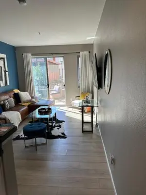 a living room with a couch and a table at Stylish Gaslamp 1BR Den Patio Walk Everywhere in San Diego