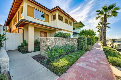 a house with a brick sidewalk in front of it at 1 Mi to Beach! San Clemente Gem with Rooftop Patios in San Clemente