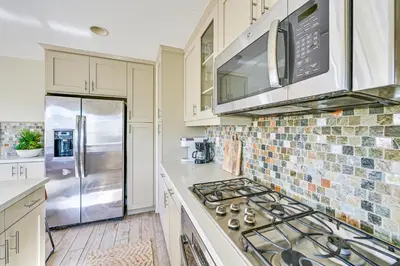 a kitchen with a stove and a refrigerator at 1 Mi to Beach! San Clemente Gem with Rooftop Patios in San Clemente