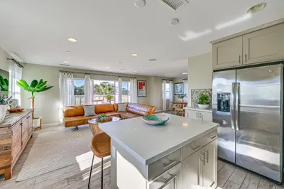 a kitchen and living room with a stainless steel refrigerator at 1 Mi to Beach! San Clemente Gem with Rooftop Patios in San Clemente