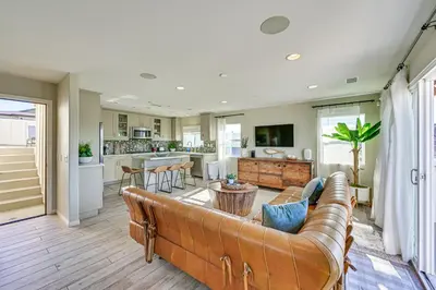 a living room with a couch and a kitchen at 1 Mi to Beach! San Clemente Gem with Rooftop Patios in San Clemente