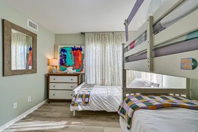 a bedroom with a bunk bed and a dresser at 1 Mi to Beach! San Clemente Gem with Rooftop Patios in San Clemente