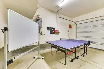a ping pong table in a room with a garage at 1 Mi to Beach! San Clemente Gem with Rooftop Patios in San Clemente