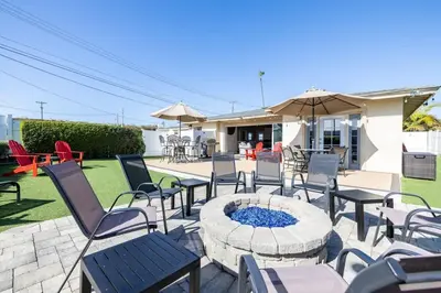 a patio with tables and chairs and a fire pit at Walk To Ponto Beach - Surf and Relax in Carlsbad