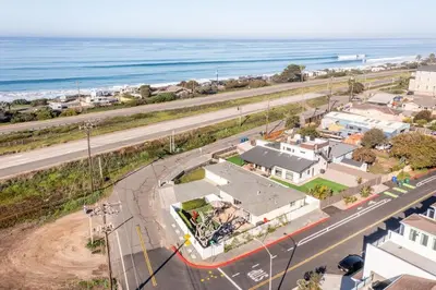 an aerial view of a town with a road and the ocean at Walk To Ponto Beach - Surf and Relax in Carlsbad