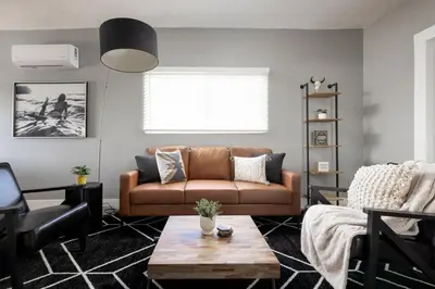 a living room with a couch and a table at The Urban Den by Coastline Vacation Rentals in San Diego