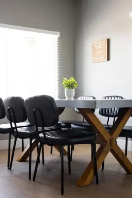 a dining room with a table and four chairs at The Urban Den by Coastline Vacation Rentals in San Diego