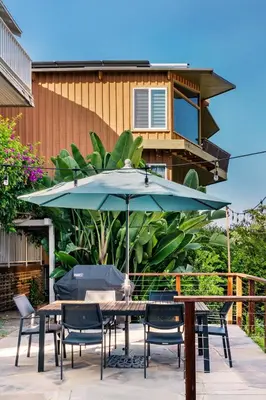 a patio with a table and chairs and an umbrella at Skyline Vista by Coastline Vacation Rentals in San Diego