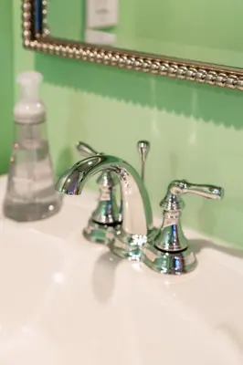 a bathroom sink with a faucet and a mirror at Skyline Vista by Coastline Vacation Rentals in San Diego