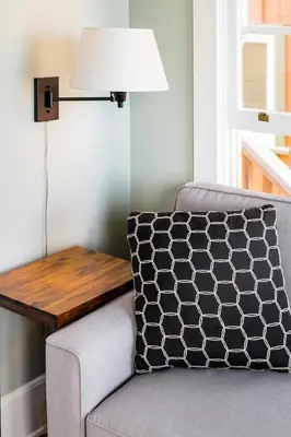 a room with a chair and a table with a lamp at Skyline Vista by Coastline Vacation Rentals in San Diego