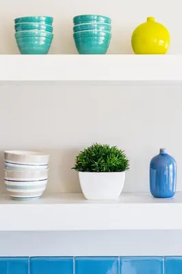 a shelf with bowls and plants on it at Skyline Vista by Coastline Vacation Rentals in San Diego