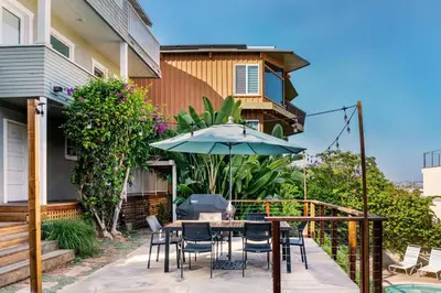 a patio with a table and chairs and an umbrella at Skyline Vista by Coastline Vacation Rentals in San Diego