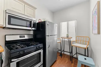 a kitchen with a stainless steel stove and a microwave at The Surf Shack by Coastline Vacation Rentals in San Diego