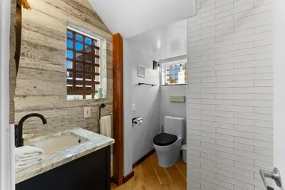 a bathroom with a sink and a toilet at Nomad Surf Lounge by Coastline Vacation Rentals in San Diego