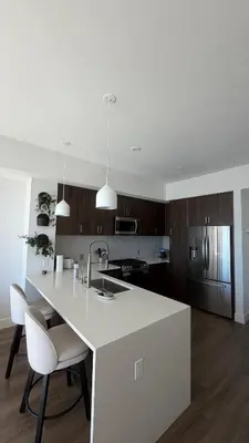a kitchen with a white counter and two chairs at Little Italy, close to everything in San Diego