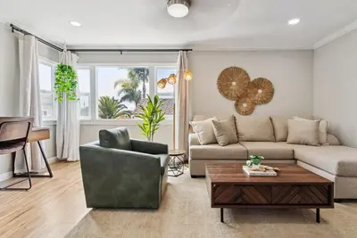 a living room with a couch and a table at Bohemian Seaside by Coastline Vacation Rentals in San Diego