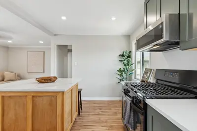 a kitchen with a stove and a counter top at Bohemian Seaside by Coastline Vacation Rentals in San Diego