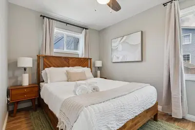 a bedroom with a bed with two towels on it at Bohemian Seaside by Coastline Vacation Rentals in San Diego