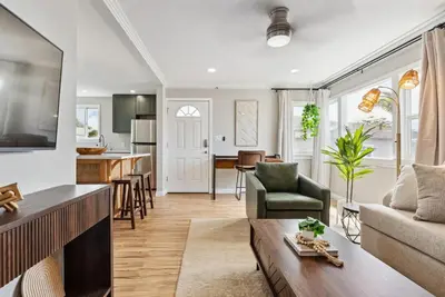 a living room with a couch and a table at Bohemian Seaside by Coastline Vacation Rentals in San Diego