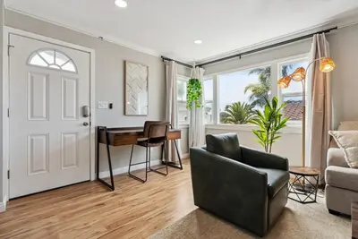 a living room with a couch and a table at Bohemian Seaside by Coastline Vacation Rentals in San Diego