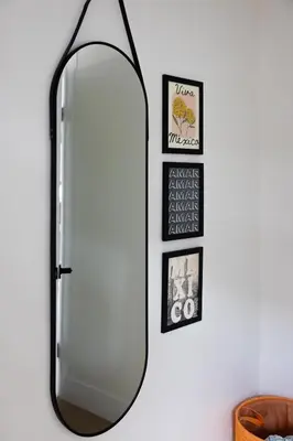 a mirror hanging on a wall with framed pictures at Casa del Sol by Coastline Vacation Rentals in San Diego