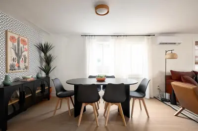 a living room with a dining room table and chairs at Casa del Sol by Coastline Vacation Rentals in San Diego