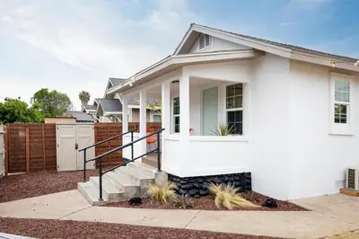 a white house with a fence at Casa del Sol by Coastline Vacation Rentals in San Diego
