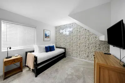 a bedroom with a bed and a tv in it at Athena FULL Property in Encinitas