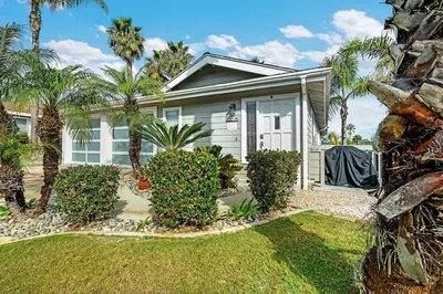 a house with palm trees in front of it at Athena FULL Property in Encinitas