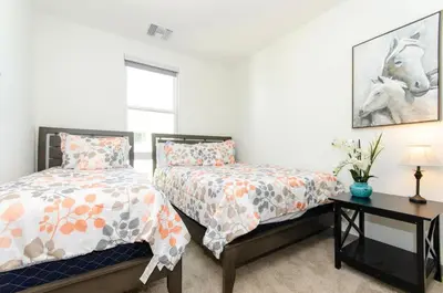 a bedroom with two beds and a table at Spacious 3bed Apt with pool close to SDCC in San Diego