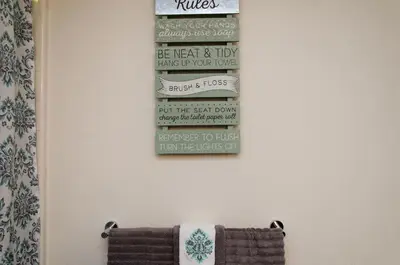 a bathroom with a stack of books on the wall at Spacious 3bed Apt with pool close to SDCC in San Diego