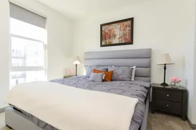 a white bedroom with a large bed and a window at Snazzy 2BR Near Petco Park & Convention Center in San Diego