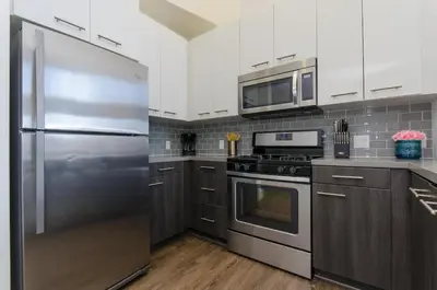 a kitchen with a stainless steel refrigerator and microwave at Snazzy 2BR Near Petco Park & Convention Center in San Diego