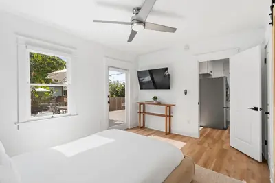 a white bedroom with a bed and a window at Cliff View - Prime Downtown La Jolla in San Diego