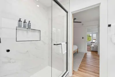 a white bathroom with a glass shower stall at Cliff View - Prime Downtown La Jolla in San Diego