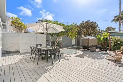 a patio with a table and chairs and an umbrella at Cliff View - Prime Downtown La Jolla in San Diego