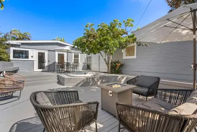 a patio with chairs and a table and an umbrella at Cliff View - Prime Downtown La Jolla in San Diego