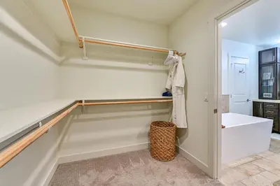 a bathroom with a tub and a sink and a toilet at Stroll to Shore Oceanside Condo with Hot Tub Access in Oceanside