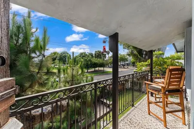 a balcony with a chair and a view of a street at Vintage Surf Hut by Coastline Vacation Rentals in San Diego