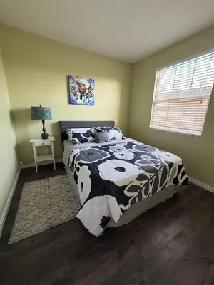 a bedroom with a black and white bed and a window at Private and Stylish 3Bdrm 3Ba Townhome, Gated Patio, King Bed, spacious in National City