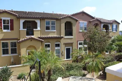 a large house with palm trees in front of it at Private and Stylish 3Bdrm 3Ba Townhome, Gated Patio, King Bed, spacious in National City