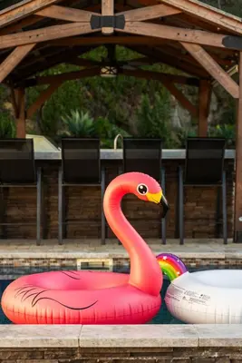 a pink flamingo float in a swimming pool at Sunset Summit by Coastline Vacation Rentals in La Mesa