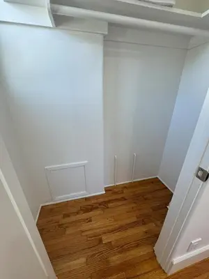 an empty room with white walls and wooden floors at South O Surf House by Coastline Vacation Rentals in Oceanside