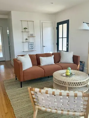 a living room with a couch and a table at South O Surf House by Coastline Vacation Rentals in Oceanside